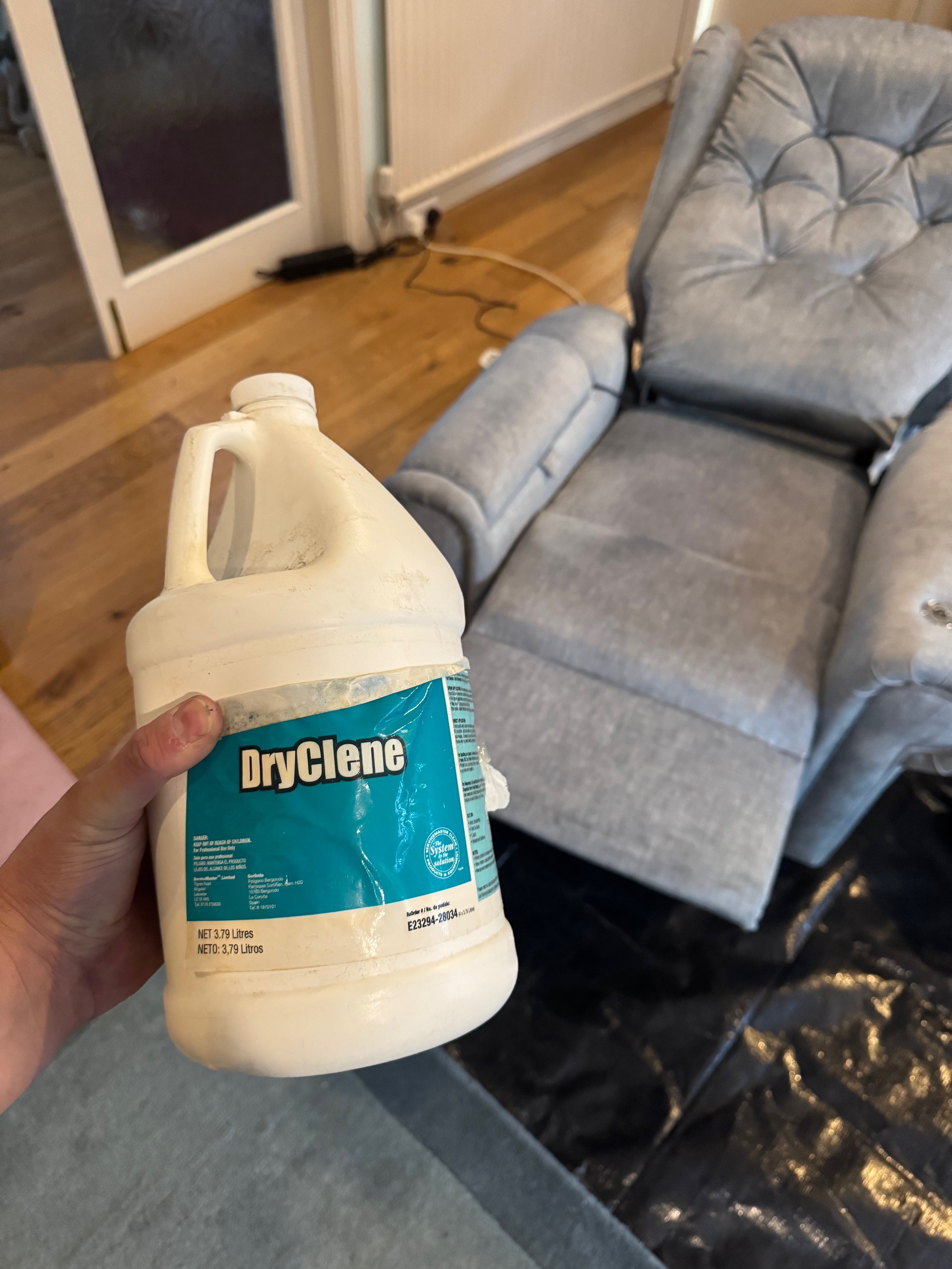 Evolve Restoration technician dry-cleaning a delicate 3-piece suite using specialist upholstery equipment.